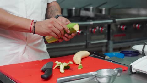 Green-banana-sault-raw-peeling-by-latin-mexican-chef-at-restaurant-kitchen-for-fried-slices
