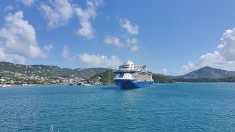 Against-this-breathtaking-backdrop,-a-majestic-cruise-ship-sails-gracefully,-adding-a-touch-of-grandeur-and-adventure-to-the-already-mesmerizing-scene-|-Vacation,-cruising,-tourism,-Caribbean,-Island