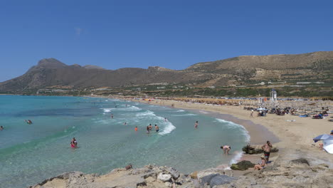 People-enjoying-beach-in-sunny-day,-Falasarna,-Crete