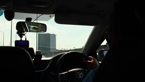 Thai-Taxi-Driver-Inside-a-Cab-Driving-on-the-Highway-in-Bangkok,-Thailand