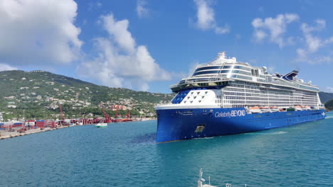 Beautiful-island-welcomes-modern-luxury-cruise-ship-Celebrity-Beyond,-Cruise-ship-approaching-island-slowly-to-dock-and-disembark-exciting-guests-inboard-vessel-|-Caribbean-island,-cruising