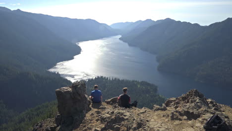 Two-friends-enjoy-view-on-Mount-Storm-King-near-Olympic-National-Park