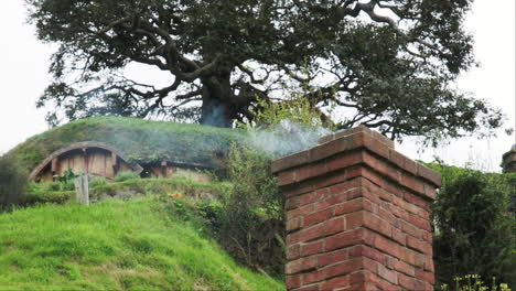 Close-up-of-smoke-billowing-from-a-charming-hobbit-chimney-at-the-Hobbiton-Movie-Set
