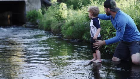 Dad-And-Son-Playing-In-Creek-Summer-Water-Bridge