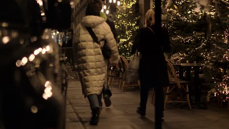 Locals-walking-the-sidewalk-on-a-calm-street-after-dark