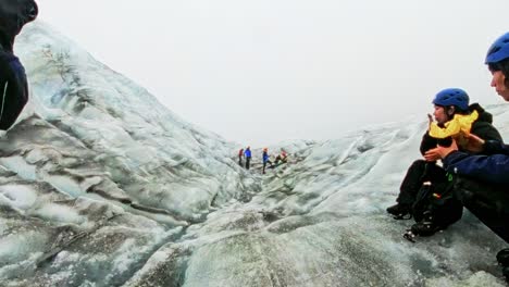 Iceland---Glacier-Hiking-Adventure-in-Vatnajökull-National-Park:-A-group-of-hikers-make-their-way-across-a-crevasse-filled-glacier,-led-by-a-certified-guide