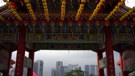 Tilt-up-view-overlooking-the-cityscape-skyline-and-the-beautiful-yellow-lanterns-celebrating-Mazu's-Birthday-in-Thean-Hou-Temple,-Kuala-Lumpur,-Malaysia
