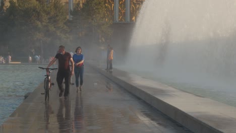 People-walking-between-Fountain-on-Independence-Square-in-Tashkent,-the-capital-of-Uzbekistan