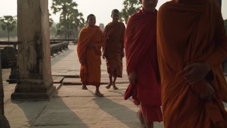 Buddhist-Monks-walking-and-Entering-Ancient-Temple-of-Angkor-Wat---Siem-Reap,-Cambodia