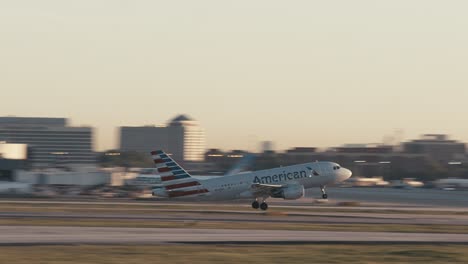 An-American-Airlines-aircraft-takes-off-down-a-runway-and-flies-into-the-sky-at-ATL-airport-in-Atlanta,-Georgia