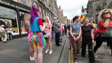 Experience-a-vibrant-POV-shot-as-you-walk-into-the-Pride-March-on-the-Royal-Mile-in-Edinburgh,-surrounded-by-a-diverse-and-colorful-crowd-expressing-their-support-for-the-LGBTQ+-community