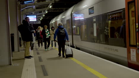 Slow-motion-shot-of-people-waiting-for-arriving-train-at-Gdansk-Airport-in-Poland