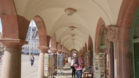 Walking-under-Old-Town-Hall-with-Touristic-Shops-next-to-Marketplace