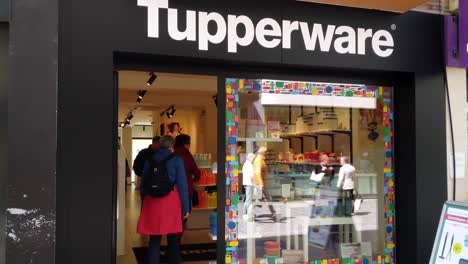 People-entering-the-Tupperware-store-in-the-shopping-street-in-Oostende,-Belgium