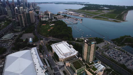 Aerial-tilt-shot-of-the-Beanfield-Centre-and-Billy-Bishop-Toronto-City-Airport,-evening-in-Canada