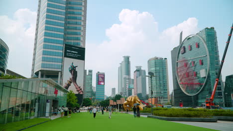 Tourists-Traveling-At-The-City-Landmarks-Nearby-Coex-Mall-With-Gangnam-Style-Statue-At-Distance-In-Seoul,-South-Korea