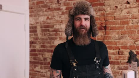 Bearded-Man-With-Fur-Hat-Authentic-Portrait-Smiling-Crossing-Arms-Small-Town-Friendly-Tattoo-Burly-Rough