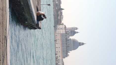 Venice,-Italy,-13th-February-2023-A-couple-seat-together-on-the-grand-canal-enjoying-the-scenics-of-Venice