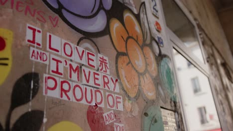 Footage-of-a-city-wall-smeared-with-graffiti-and-a-love-declaration,-it-is-full-of-color,-flowers-and-smiles