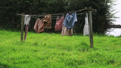 Hobbit-laundry-sways,-drying-on-a-clothesline-at-the-Hobbiton-Movie-Set