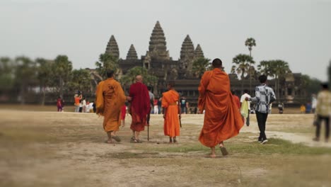 Buddhist-Monks-walking-towards-the-Ancient-Temple-of-Angkor-Wat---Siem-Reap,-Cambodia