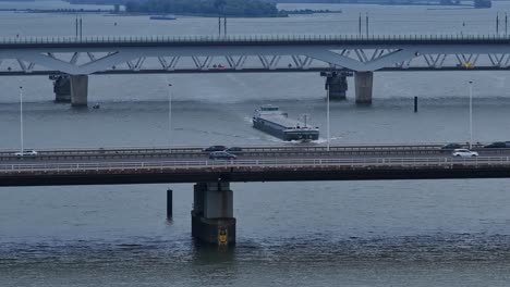 Cargo-ship,-Olesia-at-Moerdijk-sailing-under-bridges-on-the-river-Dordtsche-Kil