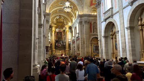 Wide-shot-showing-crowd-of-people-inside-Bom-Jesus-do-Monte-Church-during-holy-mass,-Portugal