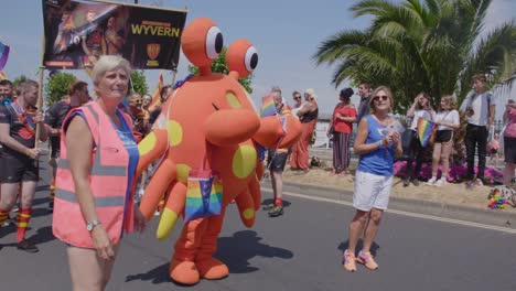 Rugby-players-and-mascot-march-in-the-parade-at-Pride-on-Isle-of-White-2018