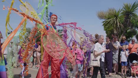Man-in-colourful-costume-walks-in-parade-at-Pride-festival-on-Isle-of-White-2018
