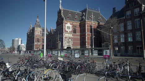Many-bicycles-parked-in-front-of-the-Central-station,-empty-street-due-to-corona-crisis-and-the-pandemic-lockdown