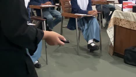 The-teacher's-hand-is-holding-a-pointer-while-teaching-in-class-in-front-of-students