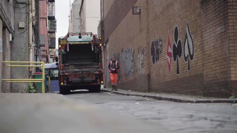 Waste-lorry-in-Glasgow-city-centre-picking-up-waste-from-the-back-of-an-alley