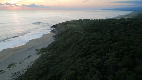 Aerial-of-sunset-at-isolated-tropical-sand-dunes-wild-beach-in-Oaxaca-Puerto-Escondido-Mexico