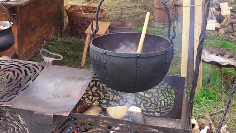 Viking-re-enactment-day-replica-stewing-pot-cooking-food-on-a-wood-fire-and-smoking-fire-at-Woodstown-Waterford-Ireland