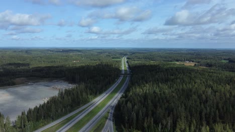 Aerial-view:-Divided-highway-cuts-through-rolling-conifer-forest