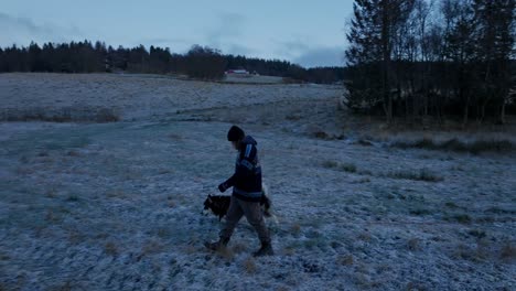 Indre-Fosen,-Kreis-Tröndelag,-Norwegen-–-Im-November-Macht-Ein-Mann-Einen-Spaziergang-Mit-Seinem-Hund-Durch-Den-Bauernhof-–-Kamerafahrt