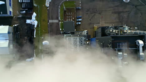 Steam-and-smoke-emissions-from-a-district-teleheating-plant---straight-down-aerial-view