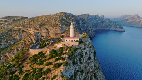 Vibrant-golden-light-spread-across-rocky-cliff-and-road-at-Formentor-lighthouse,-Serra-de-Tramuntana-Mallorca-Spain