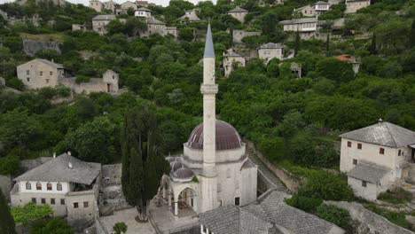 Drone-view-historical-village-with-an-ancient-castle-on-the-hill,-View-of-the-historical-mosque-in-the-village-of-Pocitelji-near-Mostar,-Bosnia-and-Herzegovina