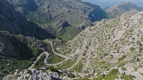 Winding-u-turn-and-snaking-bend-in-road-nestled-in-deep-valley,-Sa-calobra-road-in-Serra-de-Tramuntana-Mallorca