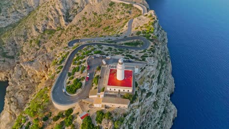 Drone-top-down-tilt-up-reveals-Formentor-lighthouse,-Serra-de-Tramuntana-Mallorca-Spain