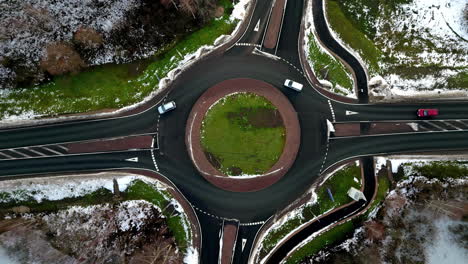 Street-roundabout-in-winter---straight-down-aerial-view-time-lapse