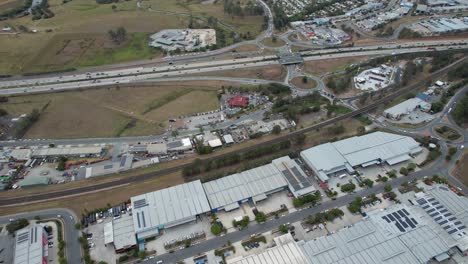 Industrial-Buildings-And-Pie-Shop-Near-Busy-Pacific-Motorway-In-Yatala,-Queensland,-Australia