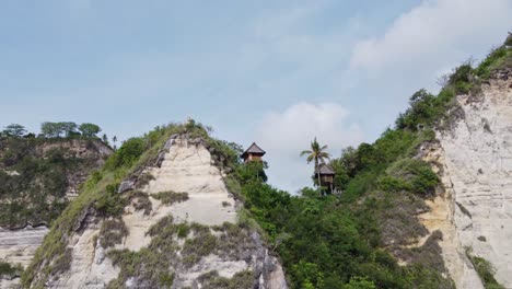 Scenic-Treehouse-huts-atop-tropical-towering-ocean-cliffs,-Nusa-Penida