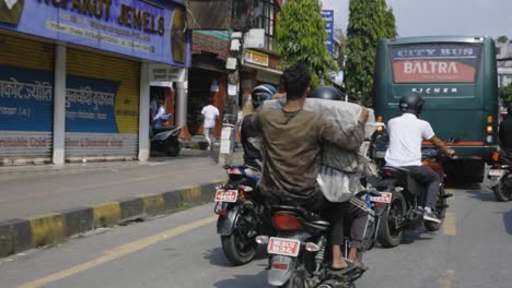 Nepalese-Men-Riding-Motorcycles-On-Busy-Street-In-Pokhara,-Nepal