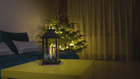 A-Candle-Lantern-Positioned-Close-to-the-Glittering-Christmas-Tree---Static-Shot