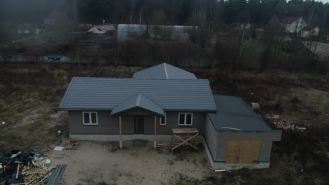 Aerial-view-of-new-build-house-in-rural-landscape-near-village-forest