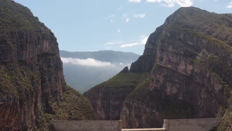Large-concrete-dam-between-steep-walls-of-gorge-in-La-Huasteca-Park,-near-Monterrey,-Mexico