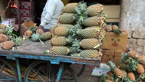 A-shopkeeper-is-selling-fresh-and-fresh-pineapple-fruit-on-the-street-road