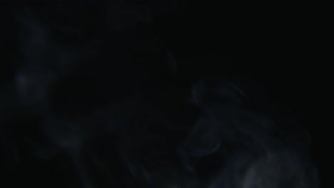 White-smoke-rising-on-black-background